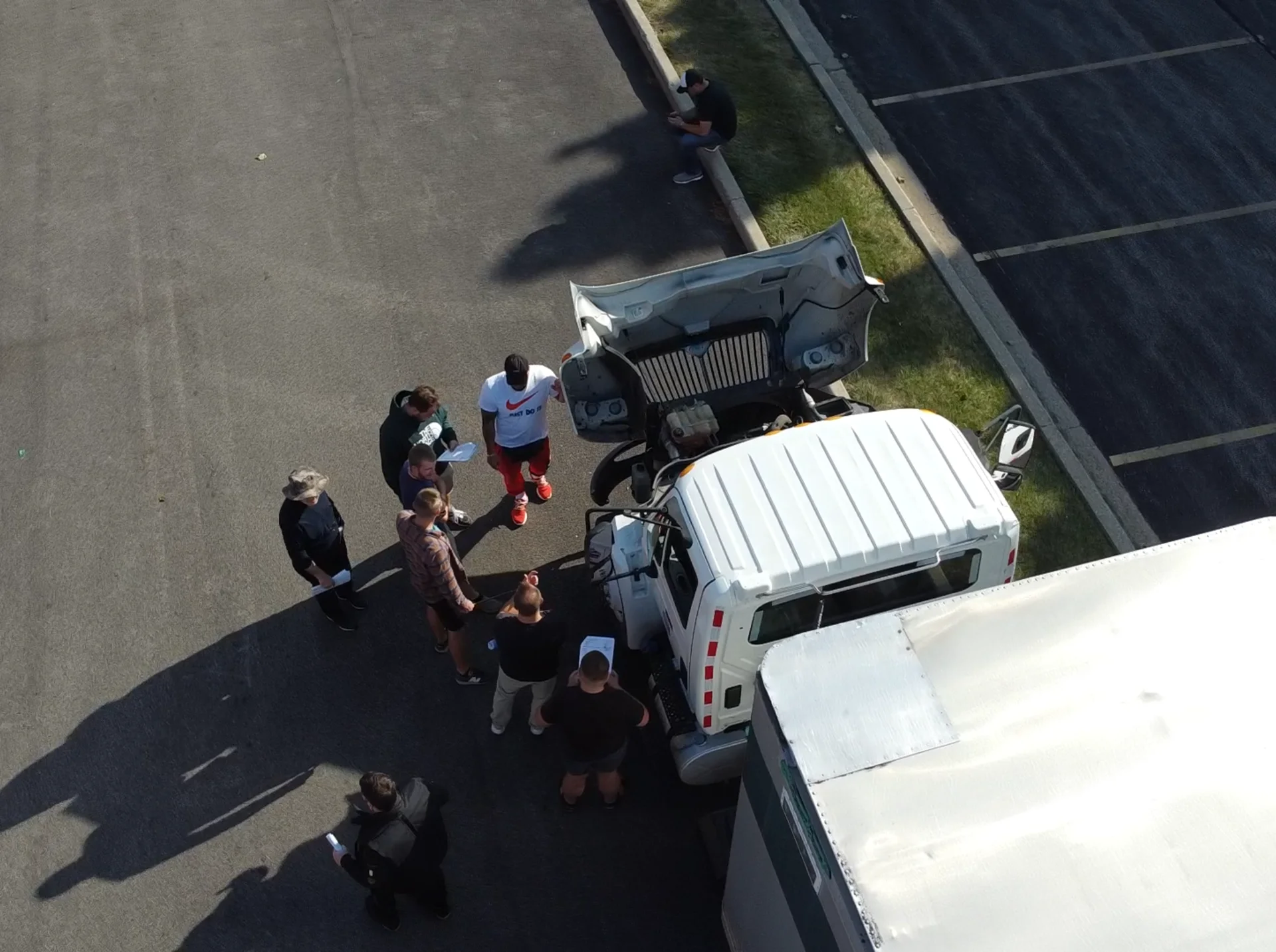 All-In CDL students and an instructor performing a pre-trip inspection at the training yard